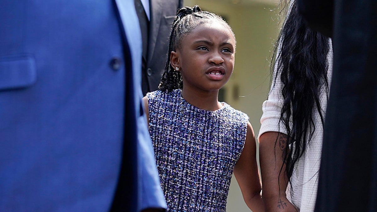 Gianna Floyd, the daughter of George Floyd, listens as family members speak to reporters after meeting with President Joe Biden at the White House, Tuesday, May 25, 2021, in Washington. (AP Photo/Evan Vucci)