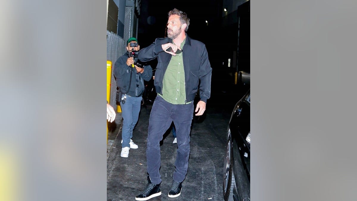 Ben Affleck attempted to hide his face from cameras with his cell phone while stepping out for dinner in Beverly Hills with JLo.