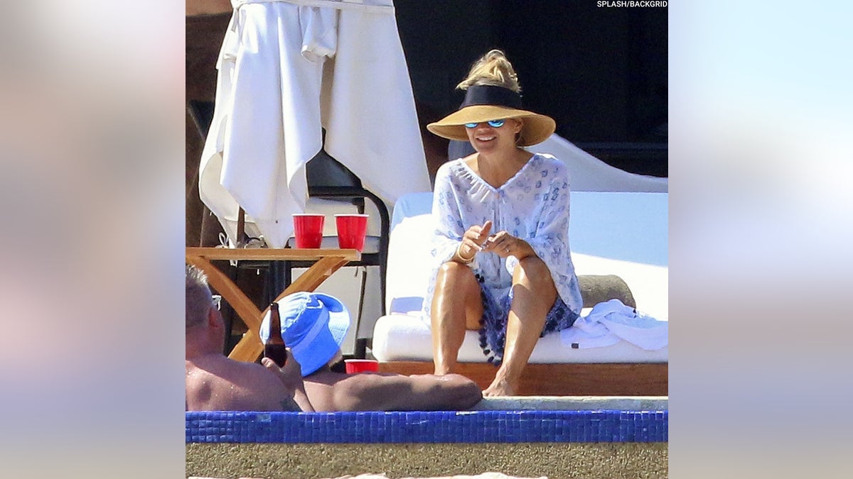 Lori Loughlin and her husband Mossimo Giannulli kick back at the pool in Mexico. 