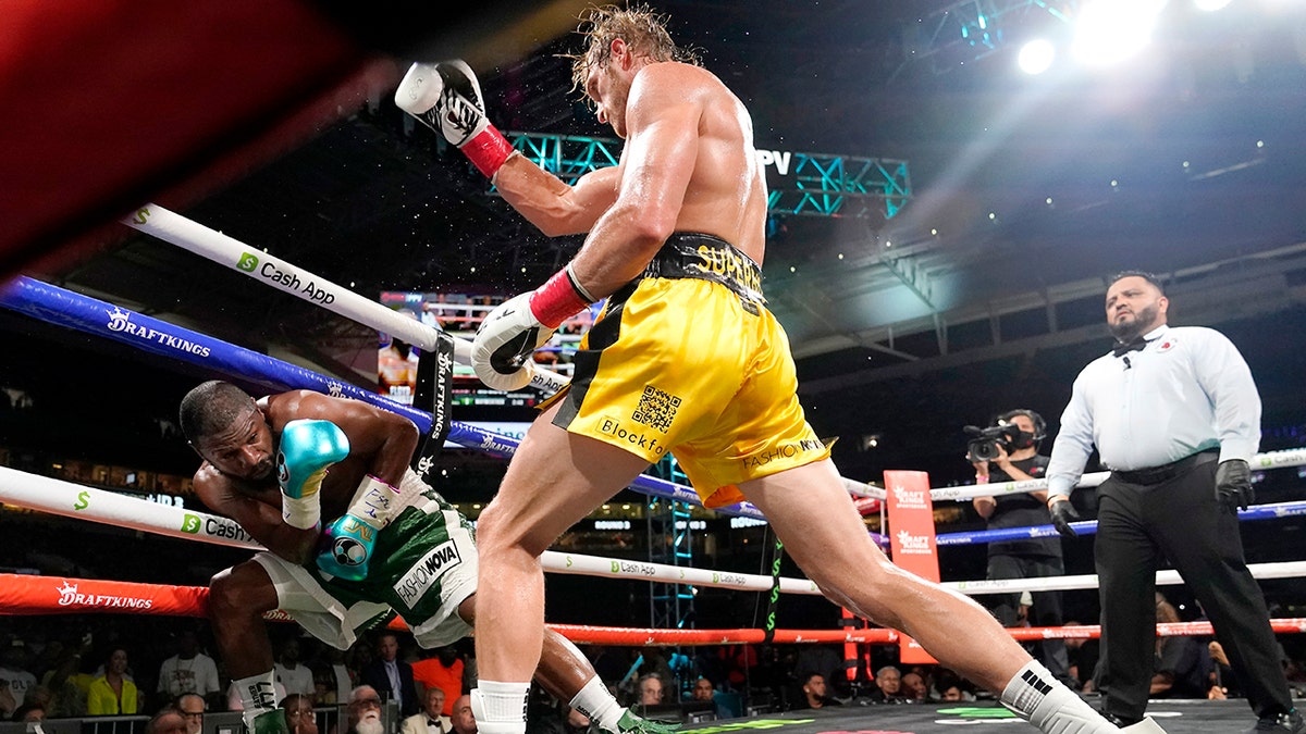 Floyd Mayweather, left, and Logan Paul fight during an exhibition boxing match at Hard Rock Stadium, Sunday, June 6, 2021, in Miami Gardens, Fla. (AP Photo/Lynne Sladky)