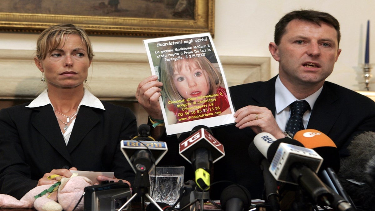 Kate McCann, left, looks on as her husband Gerry holds up a picture of their missing daughter Madeleine during a news conference in Rome, on May 30, 2007.