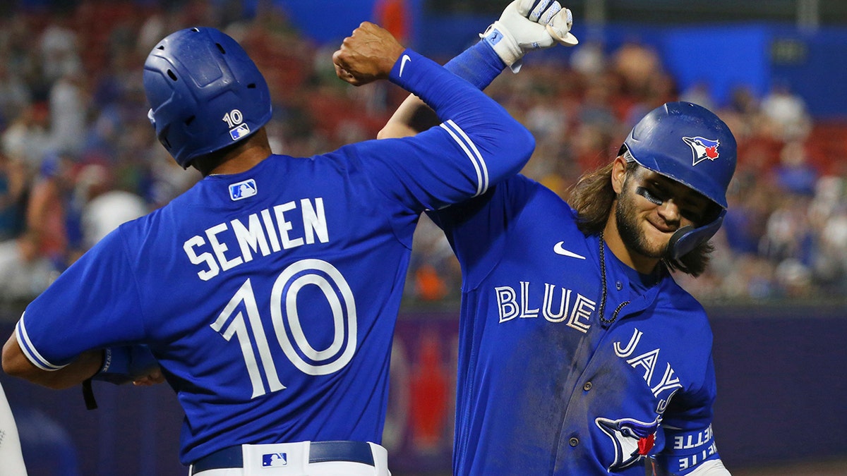 The Toronto Blue Jays' Bo Bichette, left, celebrates a three-run home run with Marcus Semien Tuesday, June 29, 2021, in Buffalo. (AP Photo/Jeffrey T. Barnes)
