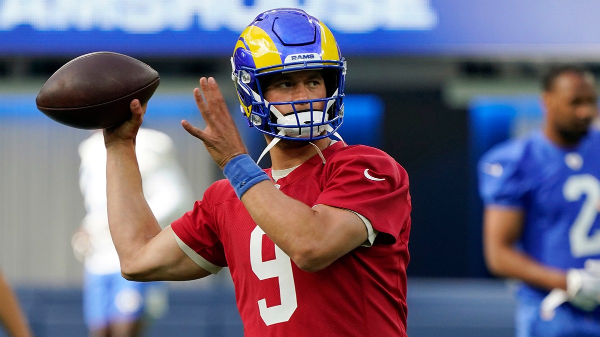 Recently acquired Los Angeles Rams quarterback Matthew Stafford throwing a ball during training camp "pictured here"