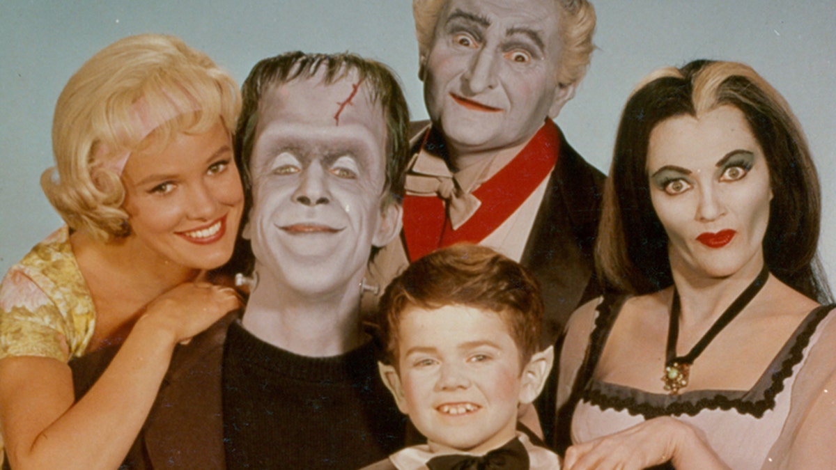 Pat Priest, Al Lewis and Butch Patrick along with Fred Gwynne and Yvonne De Carlo of the Munster family in a publicity photograph from the television series 'The Munsters', circa 1964.