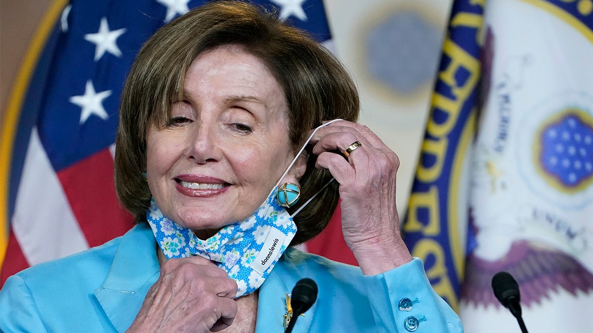In this May 19, 2021, file photo House Speaker Nancy Pelosi takes off her face mask to talk to reporters on Capitol Hill in Washington, D.C.?