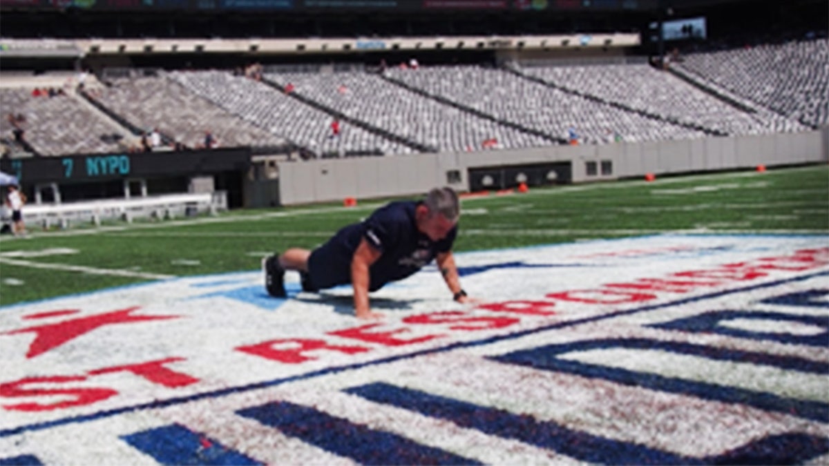 Nate Carroll on the 50-yard line of MetLife Stadium in New Jersey broke the record in front of first responders. (Tunnels to Towers Foundation)