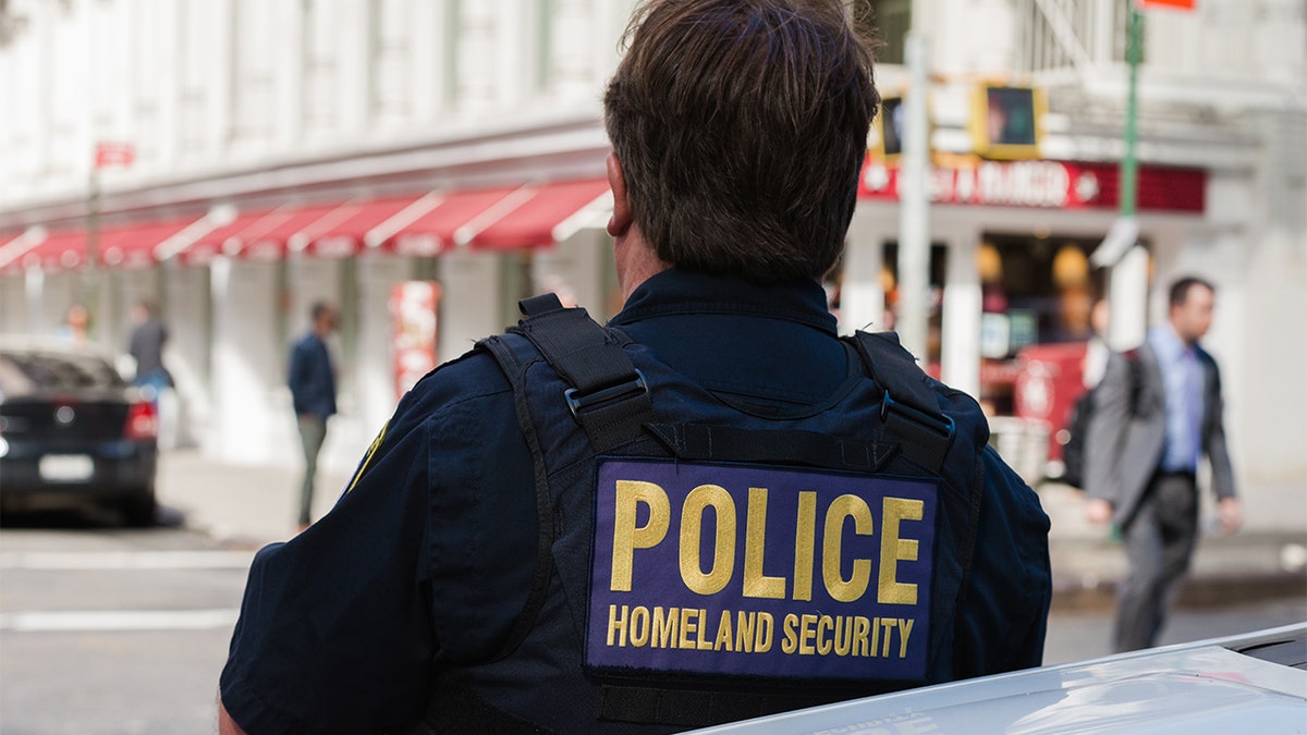The back of a Homeland Security officers vest late in the day in Lower Manhattan as a man passes late in the day. The leader of the union that represent thousands of federal law enforcement officers came out against a vaccine mandate for federal workers issued by President Biden on Thursday.