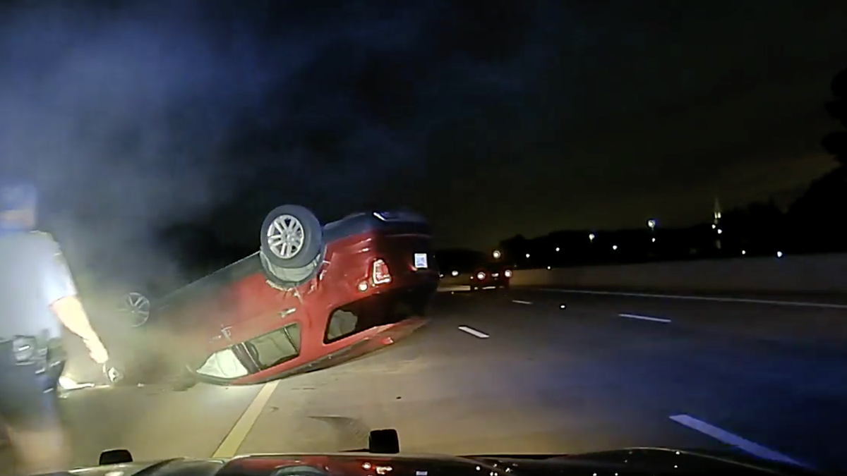 After the PIT maneuver, Harper's car came to a stop upside down in the middle of the highway. 