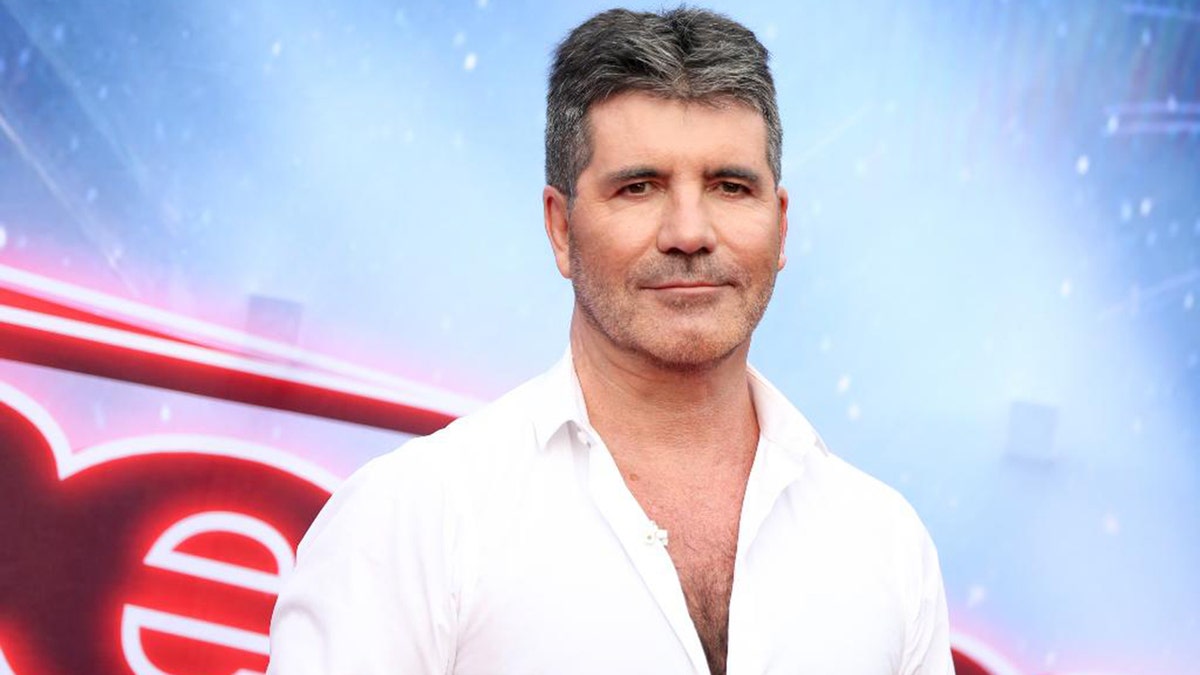 Simon Cowell reportedly popped the question while walking on the beach with his family.