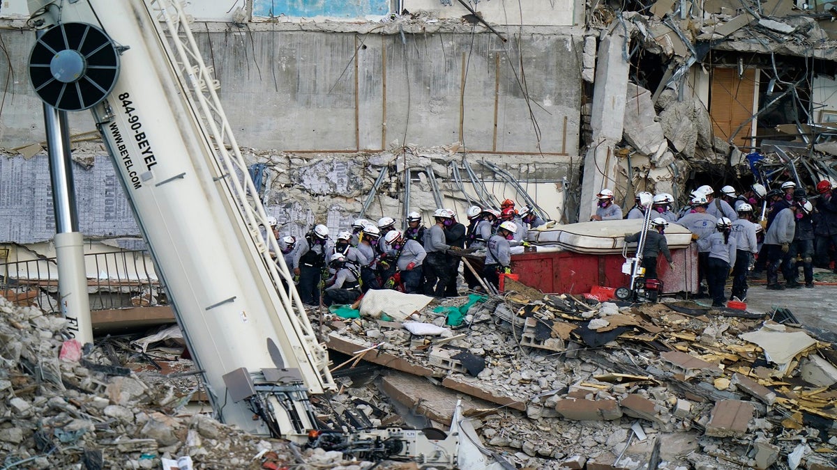 Workers search the rubble at the Champlain Towers South Condo on Monday. (AP)
