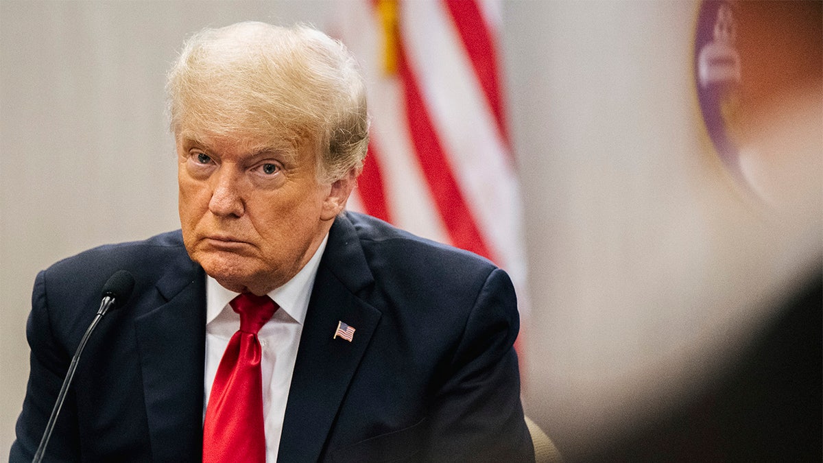 Former U.S. President Donald Trump in front of a microphone