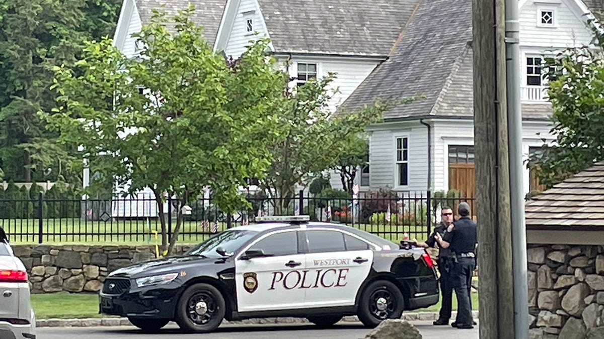 Westport, Connecticut, police officers are seen Friday outside a home where a mother and daughter were found dead Thursday. (Connor Ryan/Fox News)