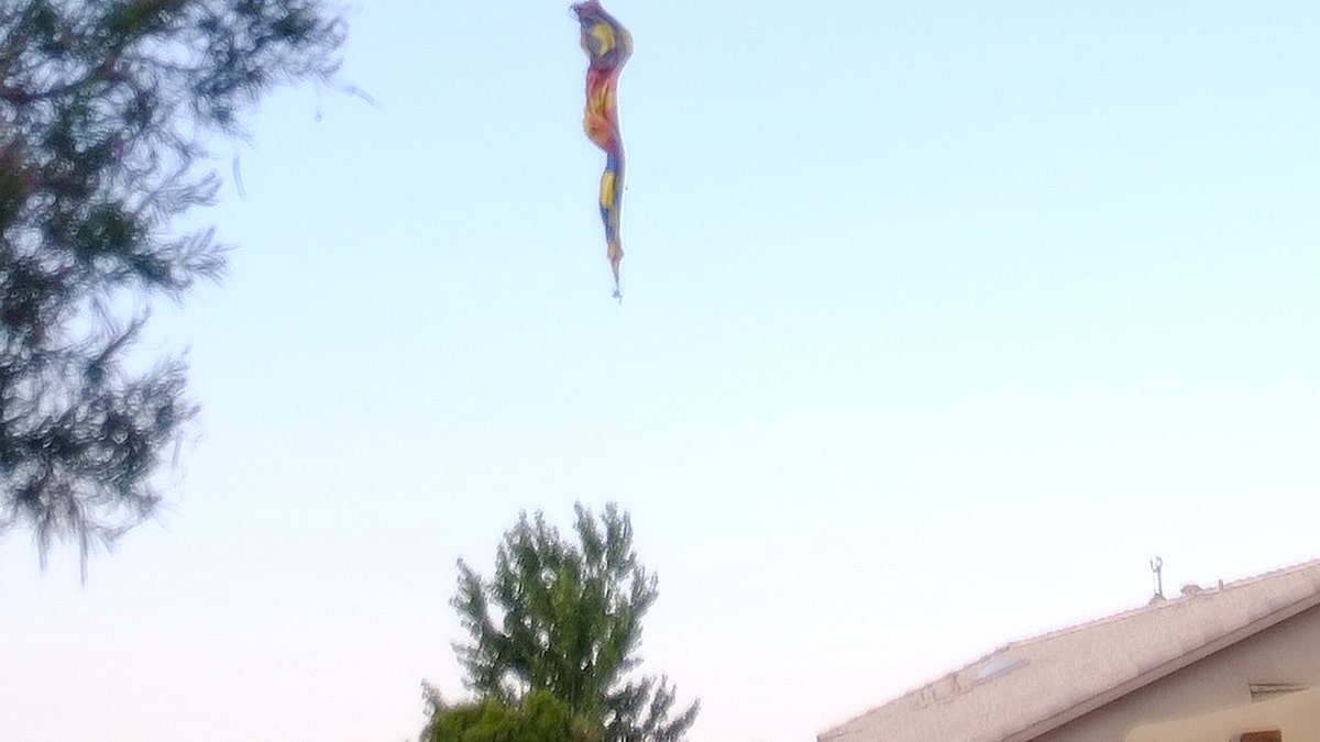 A hot-air balloon envelope falls from the sky near Unser and Central SW in Albuquerque, N.M., Saturday, June 26, 2021. Multiple people were killed in the crash. (Adolphe Pierre-Louis/The Albuquerque Journal via AP)