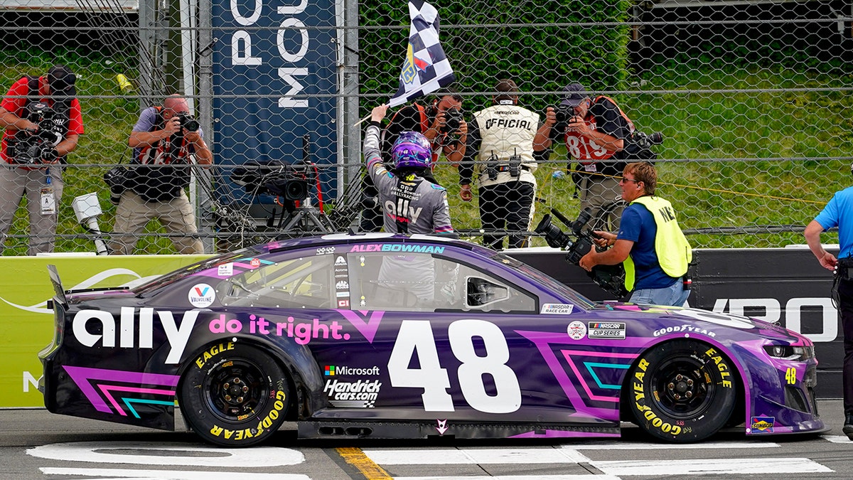 Alex Bowman waves the checkered flag after his victory at Pocono Raceway.