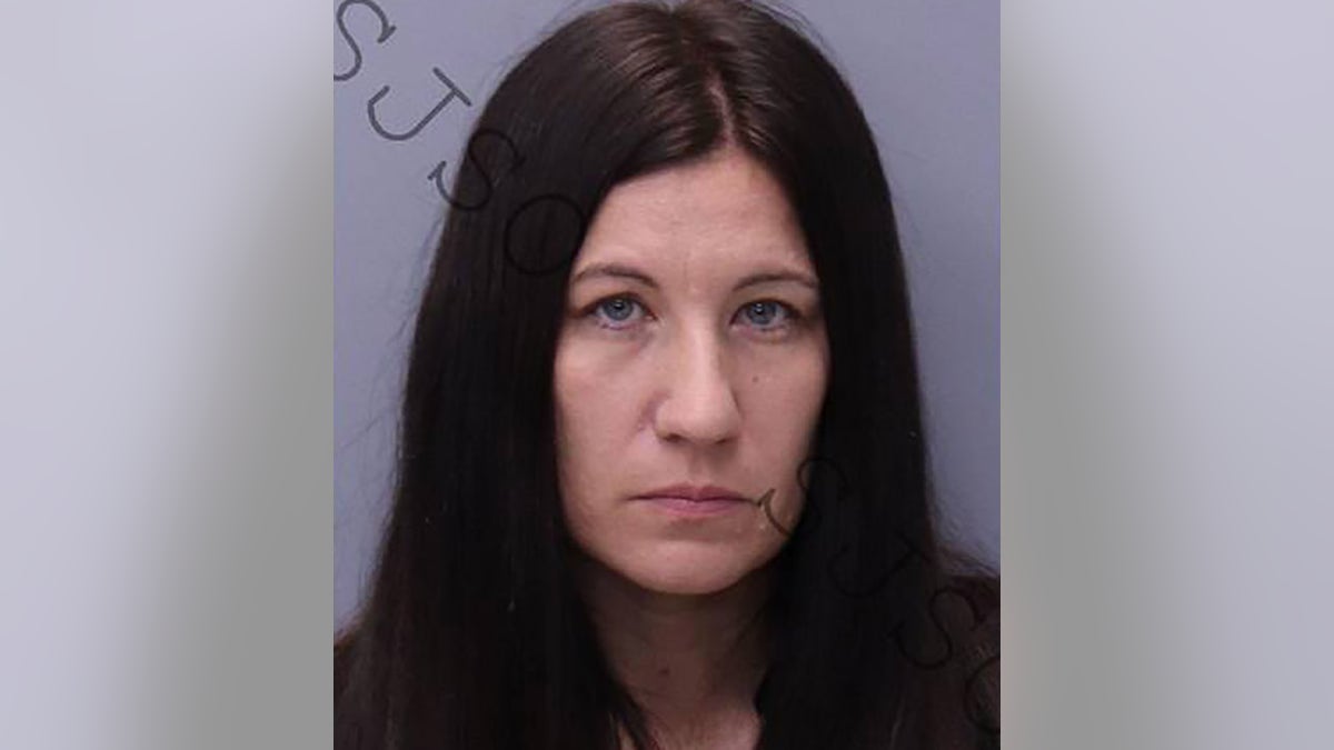 Crystal Smith frowns in mugshot