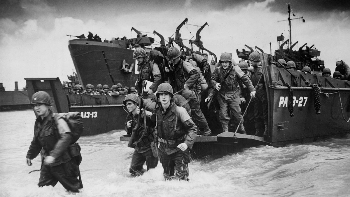 D-Day forces enter the water from docked war ships