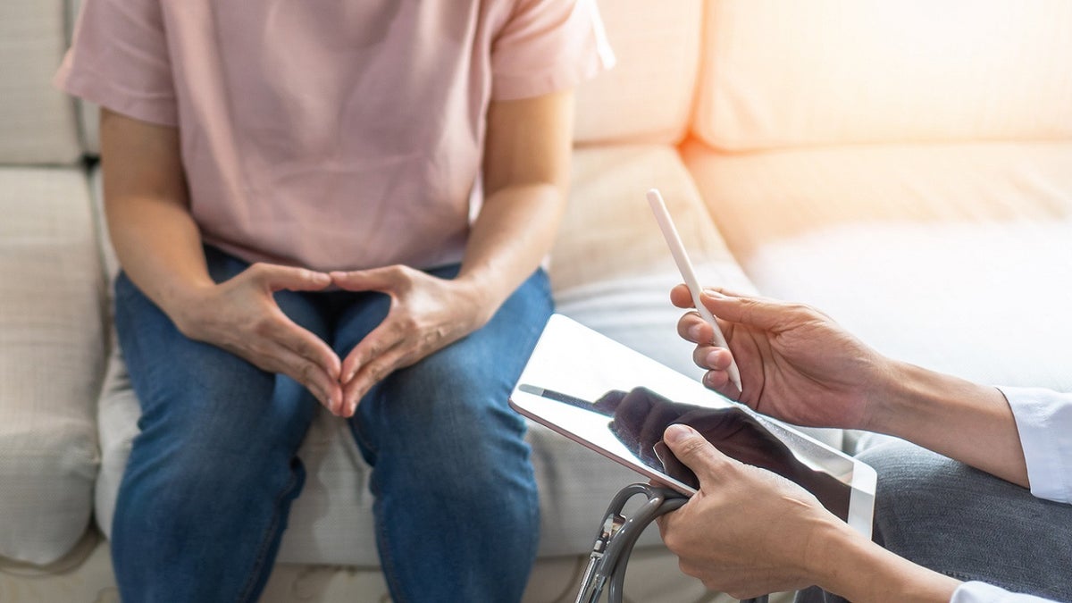 A woman speaking with a doctor