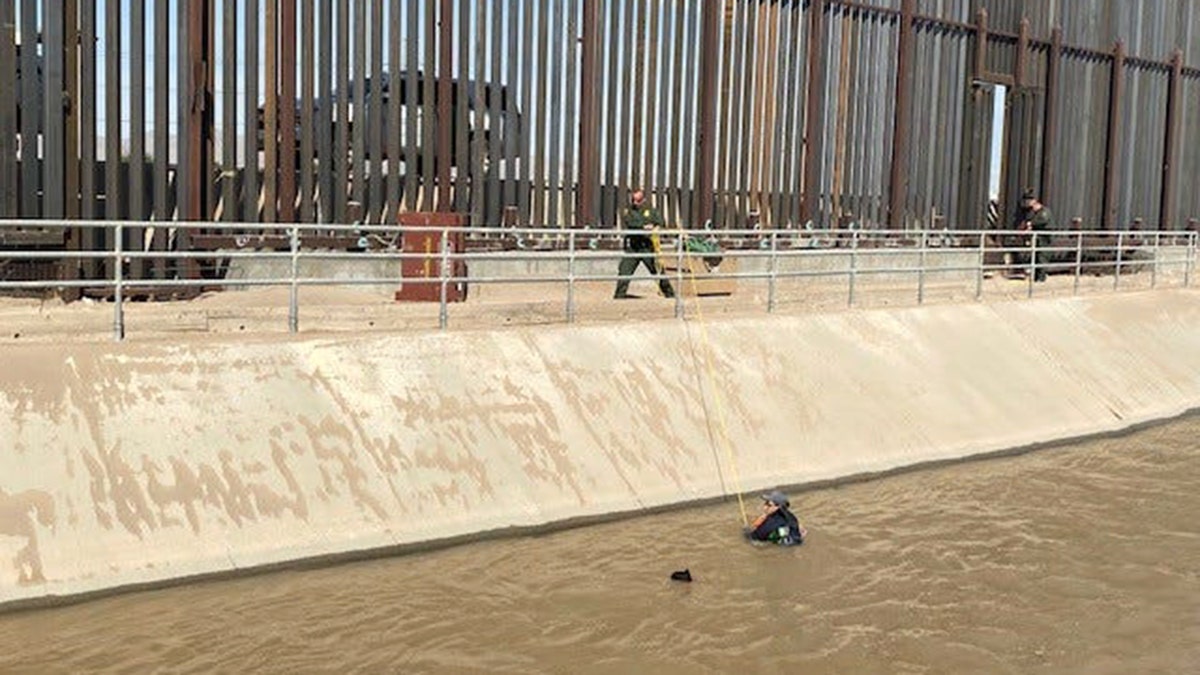 Migrants are seen being rescued by Border Patrol agents from a canal along U.S.-Mexico border near El Paso.