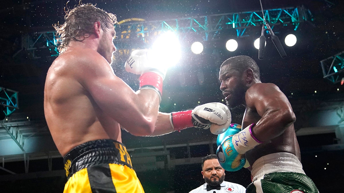 Logan Paul, left, and Floyd Mayweather fight during an exhibition boxing match at Hard Rock Stadium, Sunday, June 6, 2021, in Miami Gardens, Fla. (AP Photo/Lynne Sladky)