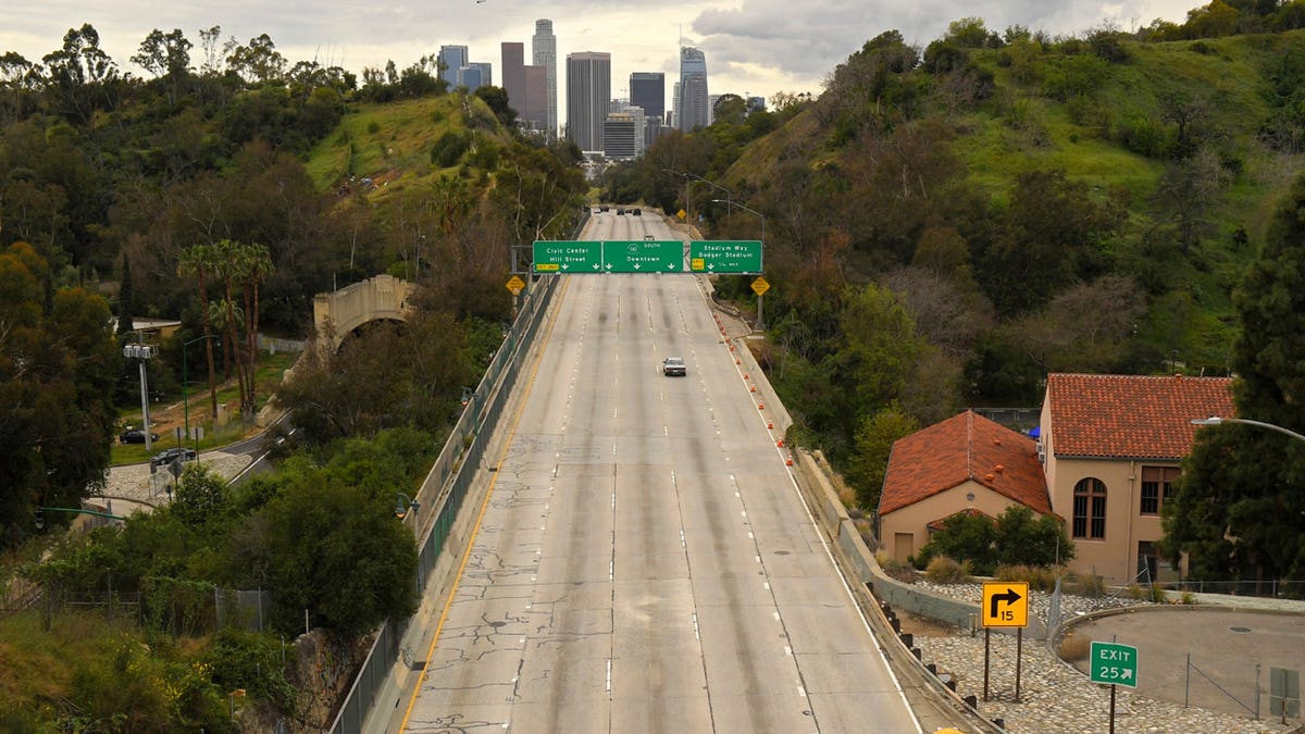 Extremely light traffic moves along the 110 Harbor Freeway toward downtown Los Angeles in mid-afternoon, March 20, 2020. (Associated Press)