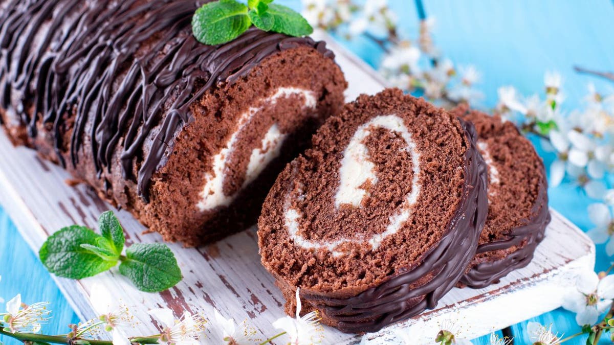 A Swiss roll is typically made from a cream- or jelly-covered sheet cake that's been rolled into the shape of a log. The two layers create a swirling design within the dessert's interior. (iStock)