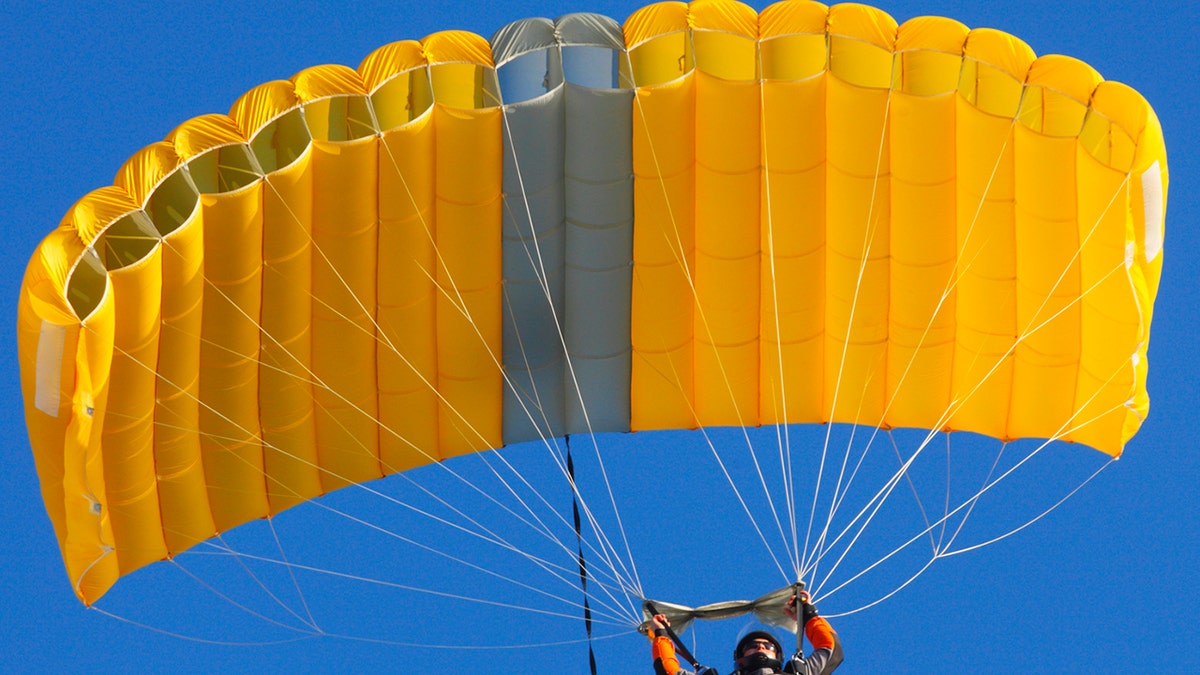 Skydiver with yellow parachut