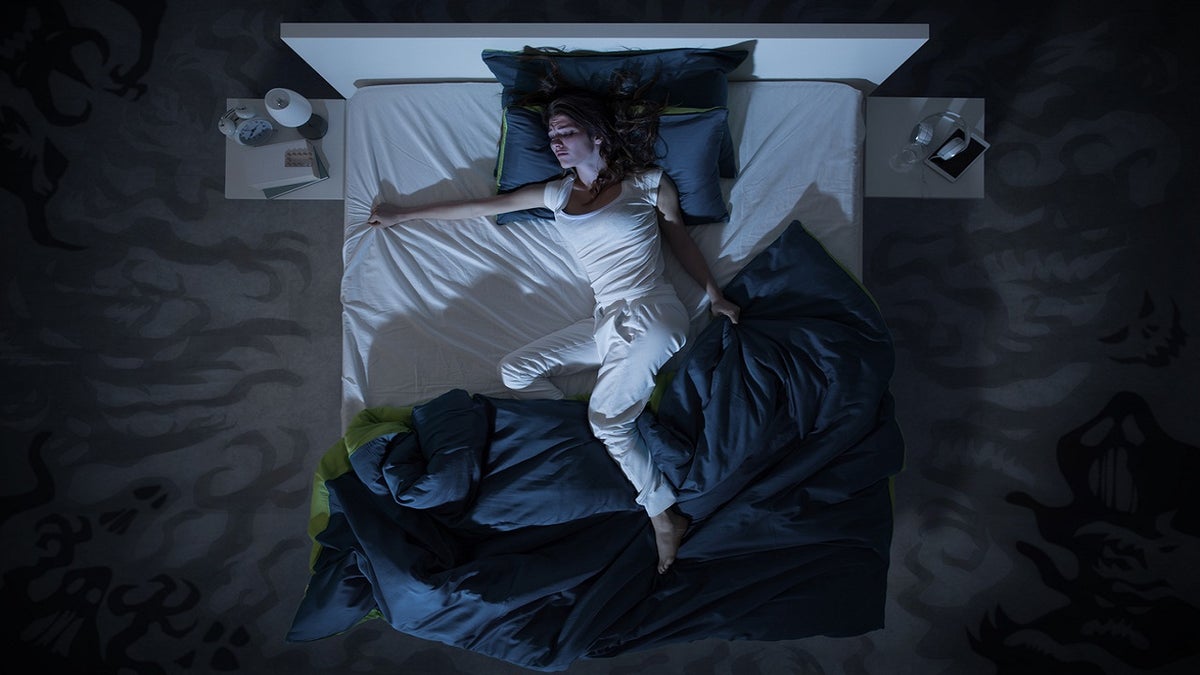 Insomnia: Woman having troubling sleeping at night in bed