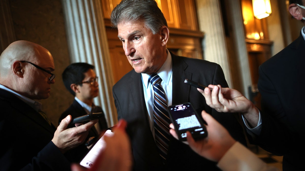 Sen. Joe Manchin talks with reporters