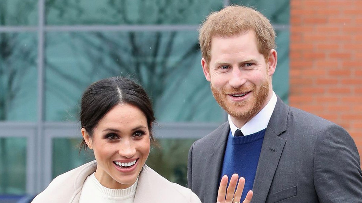 Meghan Markle and Prince Harry pose for a photo