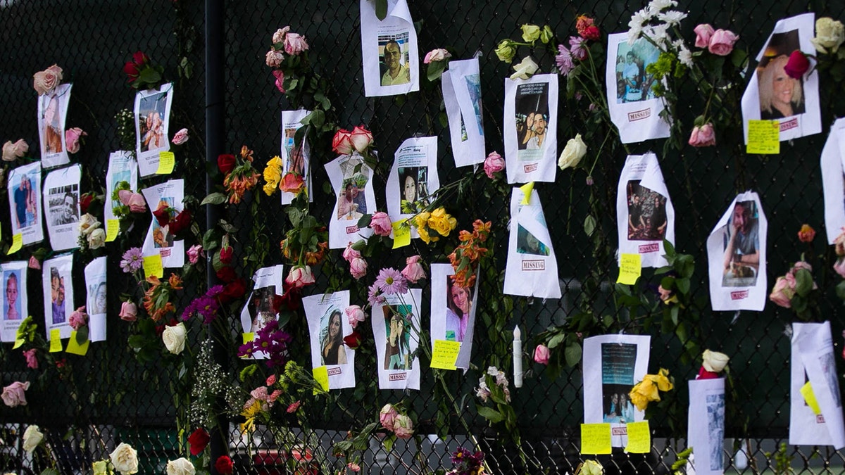 Photos of missing residents are posted at a makeshift memorial at the site of a collapsed building in Surfside, Florida, north of Miami Beach, on June 26, 2021. (Getty Images)