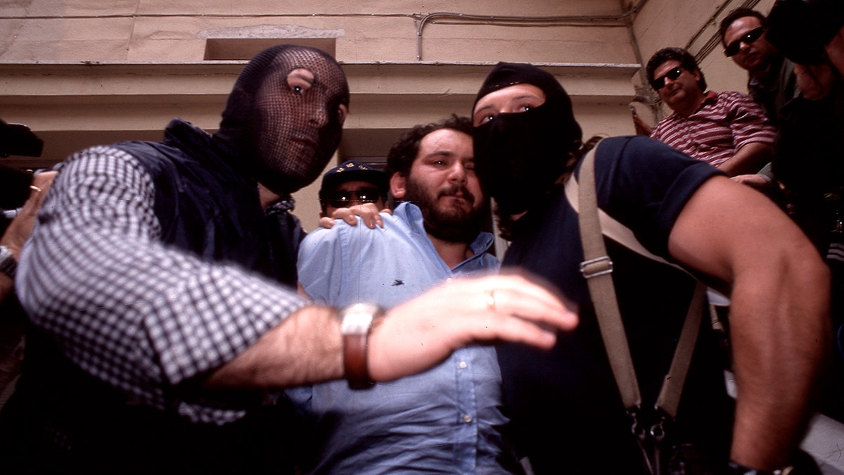Giovanni Brusca, center, is seen during his capture in 1996. (Getty Images)