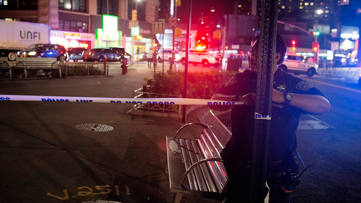 New York City police officers secure and investigate a shooting scene on August 20, 2020 in downtown Brooklyn, New York. (Photo by Andrew Lichtenstein/Corbis via Getty Images)