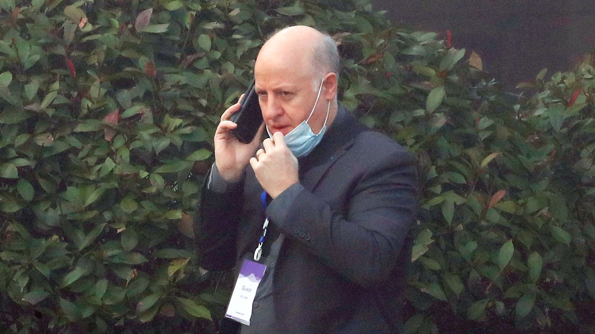 FILE PHOTO: Peter Daszak, a member of the World Health Organization (WHO) team tasked with investigating the origins of the coronavirus disease (COVID-19), uses his mobile phone at a hotel in Wuhan, Hubei province, China February 3, 2021. REUTERS/Thomas Peter/File Photo
