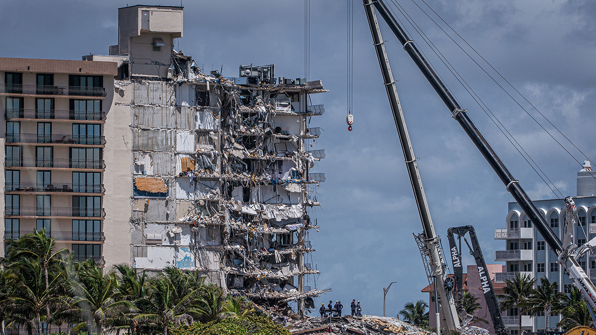 Members of the South Florida Urban Search and Rescue team look for possible survivors in the partially collapsed 12-story Champlain Towers South condo building on June 27, 2021 in Surfside, Florida. (Getty Images)