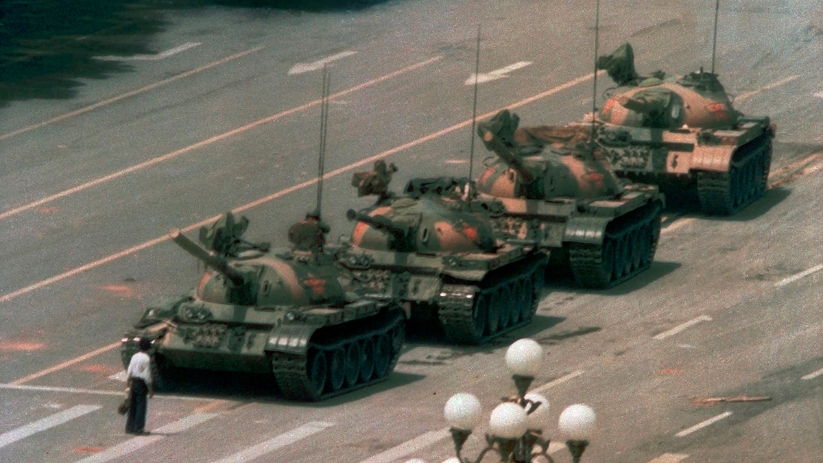 In this June 5, 1989, file photo, a man stands alone in front of a line of tanks heading east on Beijing's Changan Boulevard in Tiananmen Square, China. 