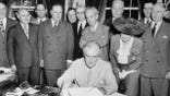 President Franklin Roosevelt today signed the G.I.Bill of Rights, which provides broad benefits for veterans of World War II. The ceremony was witnessed by members of the Senate and House and members of the American Legion and Veterans of Foreign Wars. L to right, front row in rear of President: Senator Bennett Champ Clark of MO; Congressman J. Hardin Peterson of FL; Congressman John Rankin of MS; and Edith Nourse Rogers of MA. Leaning back over the President: Senator Walter F.George of GA. In back of Mrs.Rogers: Senator Robert F. Wagner of NY, and Senator Alben Barkley of KY.