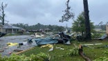 This photo provided by Alicia Jossey shows debris covering the street in East Brewton, Ala., on Saturday, June 19, 2021.  Authorities in Alabama say a suspected tornado spurred by Tropical Storm Claudette demolished or badly damaged at least 50 homes in the small town just north of the Florida border. (Alicia Jossey via AP)