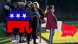 People wear protective face masks as they wait in line to vote at the Bell Shoals Baptist Church on election day Tuesday, Nov. 3, 2020, in Brandon, Fla. (AP Photo/Chris O'Meara)