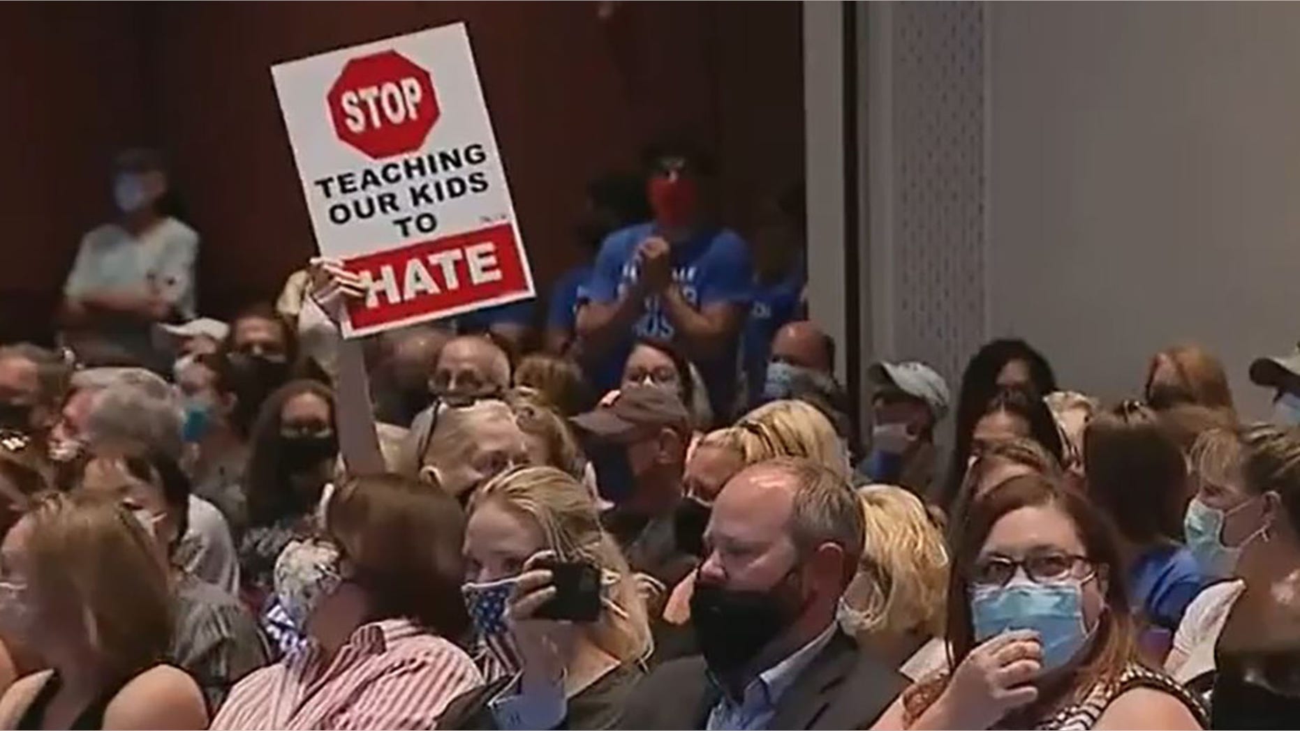 A Loudoun school board meeting erupted in chaos as parents, educators condemned decision to put teacher Tanner Cross on leave.