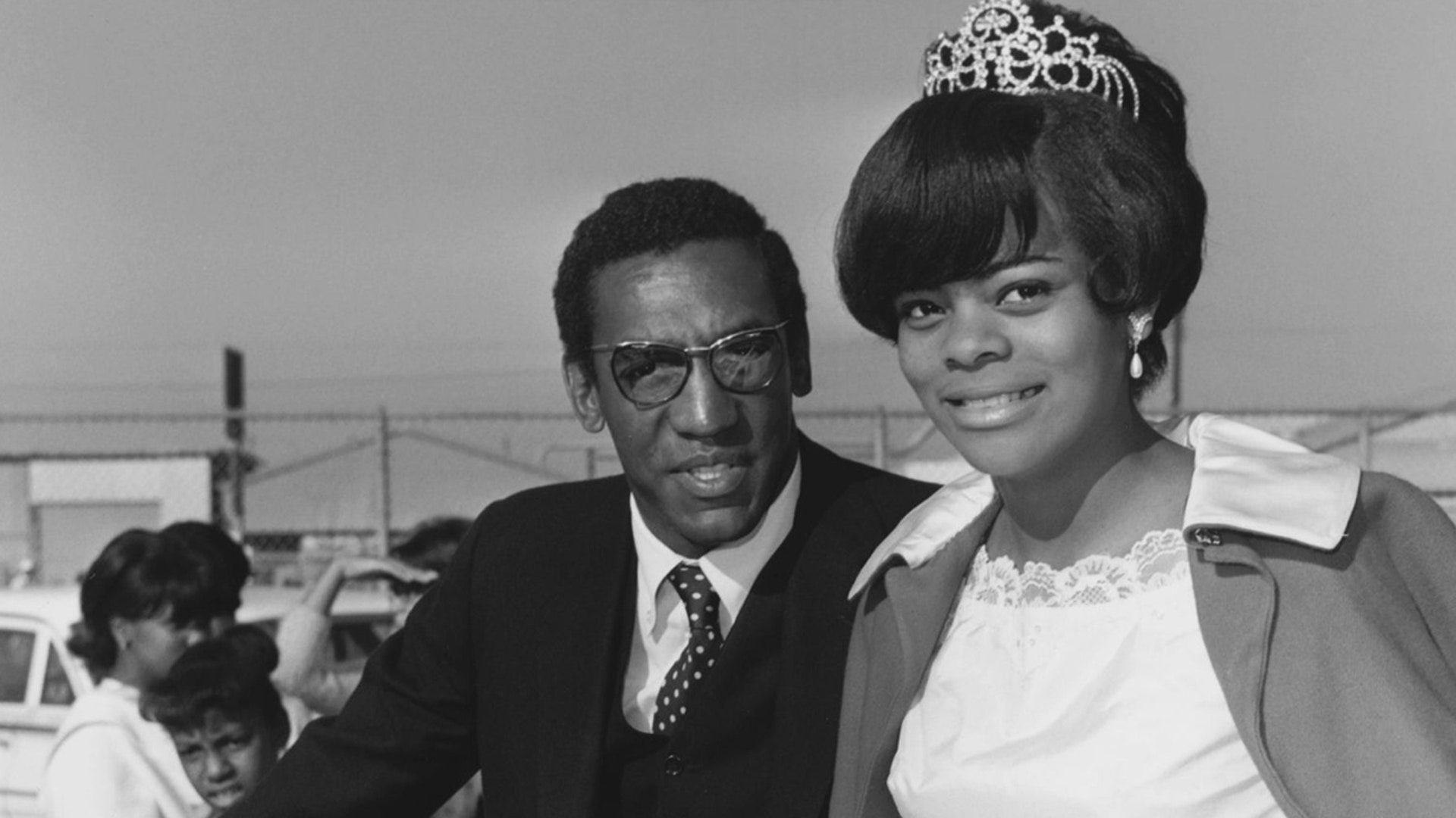 Bill Cosby on a float with the parade queen in Watts, Los Angeles in December 1966.