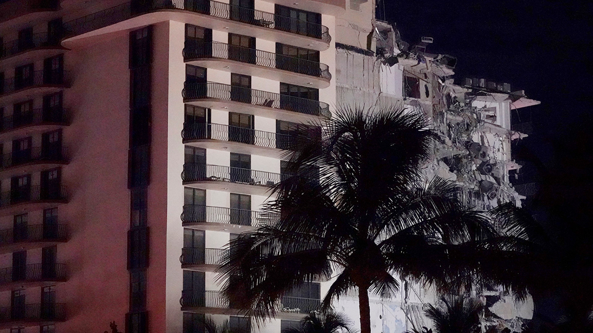 A partially collapsed building is seen early Thursday, June 24, 2021, in the Surfside area of Miami, Fla. A partial building collapse in Miami caused a massive response early Thursday from Miami Dade Fire Rescue, according to a tweet from the department's account. Miami Dade Fire Rescue is conducting search and rescue. Authorities had no word yet on casualties, or details of how many people lived in the building. (AP Photo/Wilfredo Lee)
