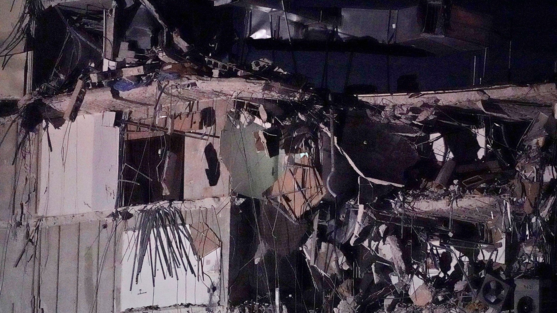 A partially collapsed building is seen early Thursday, June 24, 2021, in the Surfside area of Miami, Fla. A partial building collapse in Miami caused a massive response early Thursday from Miami Dade Fire Rescue, according to a tweet from the department's account. Miami Dade Fire Rescue is conducting search and rescue. Authorities had no word yet on casualties, or details of how many people lived in the building. (AP Photo/Wilfredo Lee)