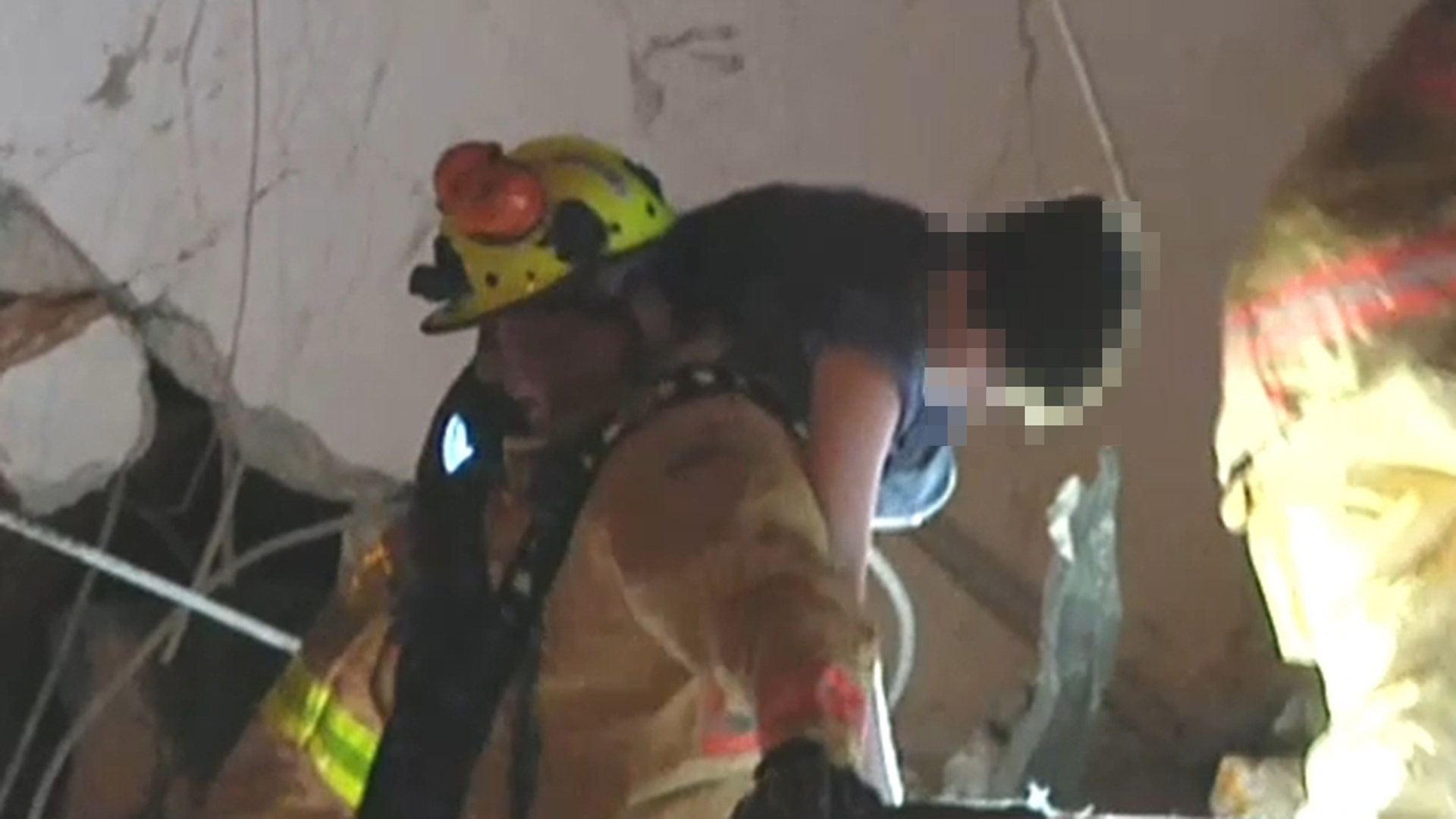 Miami-Dade fire rescue pull a boy from the rubble alive. 