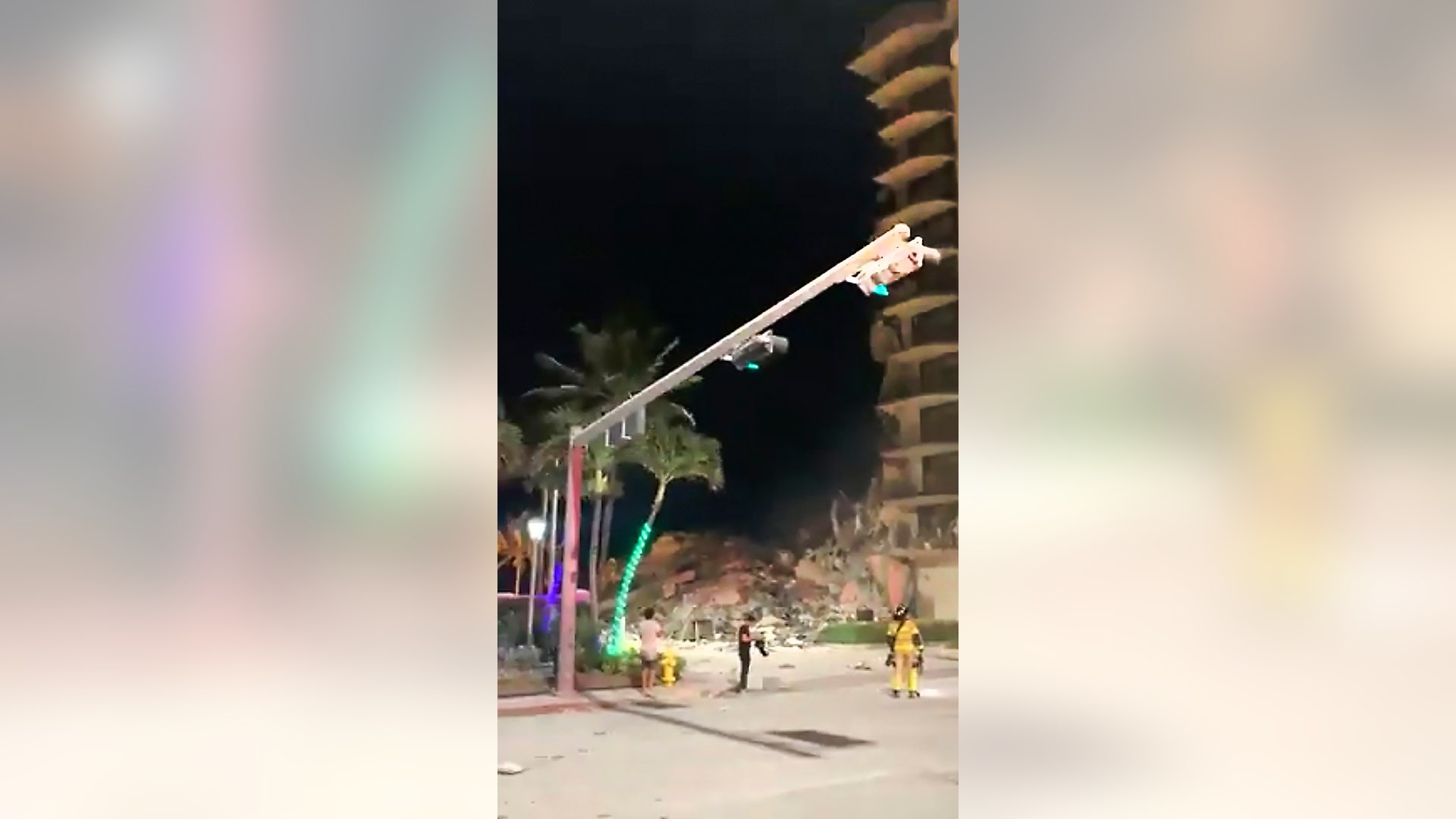 In this image made from video, officials arrive on the scene of a building collapse in Surfside, Miami, Florida, early Thursday, June 24, 2021. A partial building collapse in Miami caused a massive response early Thursday from Miami Dade Fire Rescue, according to a tweet from the department's account. Miami Dade Fire Rescue is conducting search and rescue. Authorities had no word yet on casualties, or details of how many people lived in the building. (Jamal Akakpo via AP)