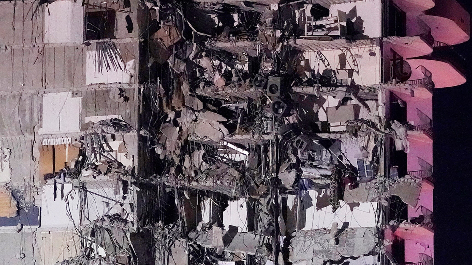 A section of a partially collapsed building is seen early Thursday, June 24, 2021, in the Surfside area of Miami, Fla. A partial building collapse in Miami caused a massive response early Thursday from Miami Dade Fire Rescue, according to a tweet from the department's account. Miami Dade Fire Rescue is conducting search and rescue. Authorities had no word yet on casualties, or details of how many people lived in the building. (AP Photo/Wilfredo Lee)