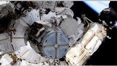 Spacewalking astronauts boosting station's solar power