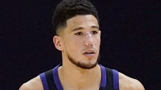 Suns' Devin Booker bloodied after head bump, returns with stitches