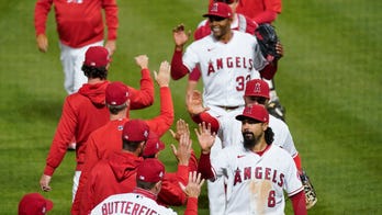 Angels fan gets hit in throat, crashes into table in epic foul ball chase