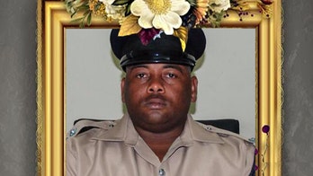 Socialite Jasmine Hartin walks past shrine to top Belize cop she is charged with fatally shooting