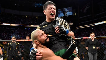 UFC's Brandon Moreno celebrates with opponent Deiveson Figueiredo after flyweight title victory